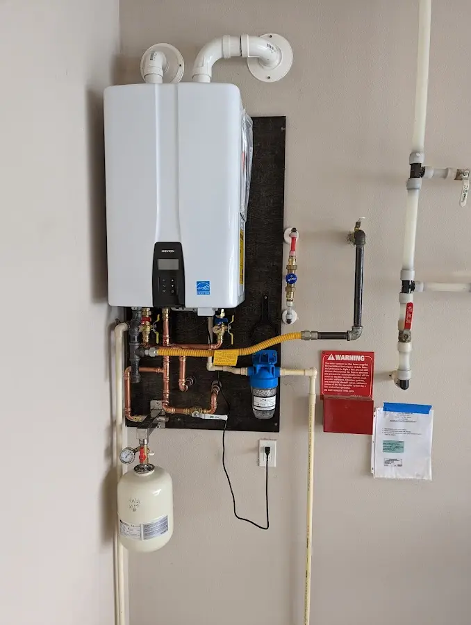 Professional plumber installing copper piping in a Fulshear home